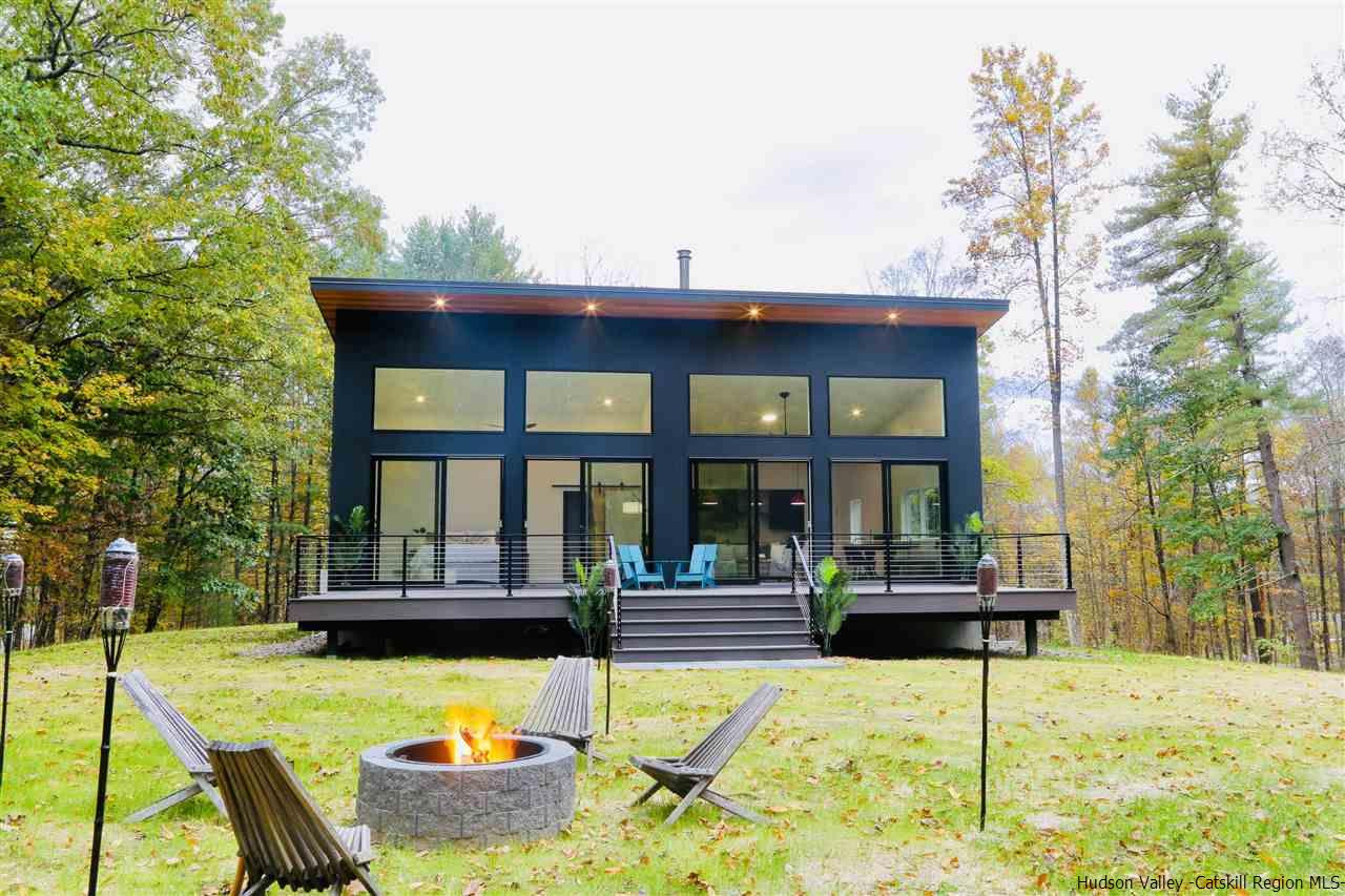 a view of a house with swimming pool and sitting area