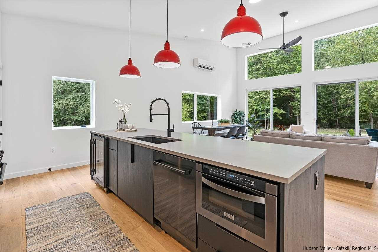 139 Krum Road Kerhonkson, NY 12446 - Photo 12 of 35 a kitchen with a sink a chandelier and a stove