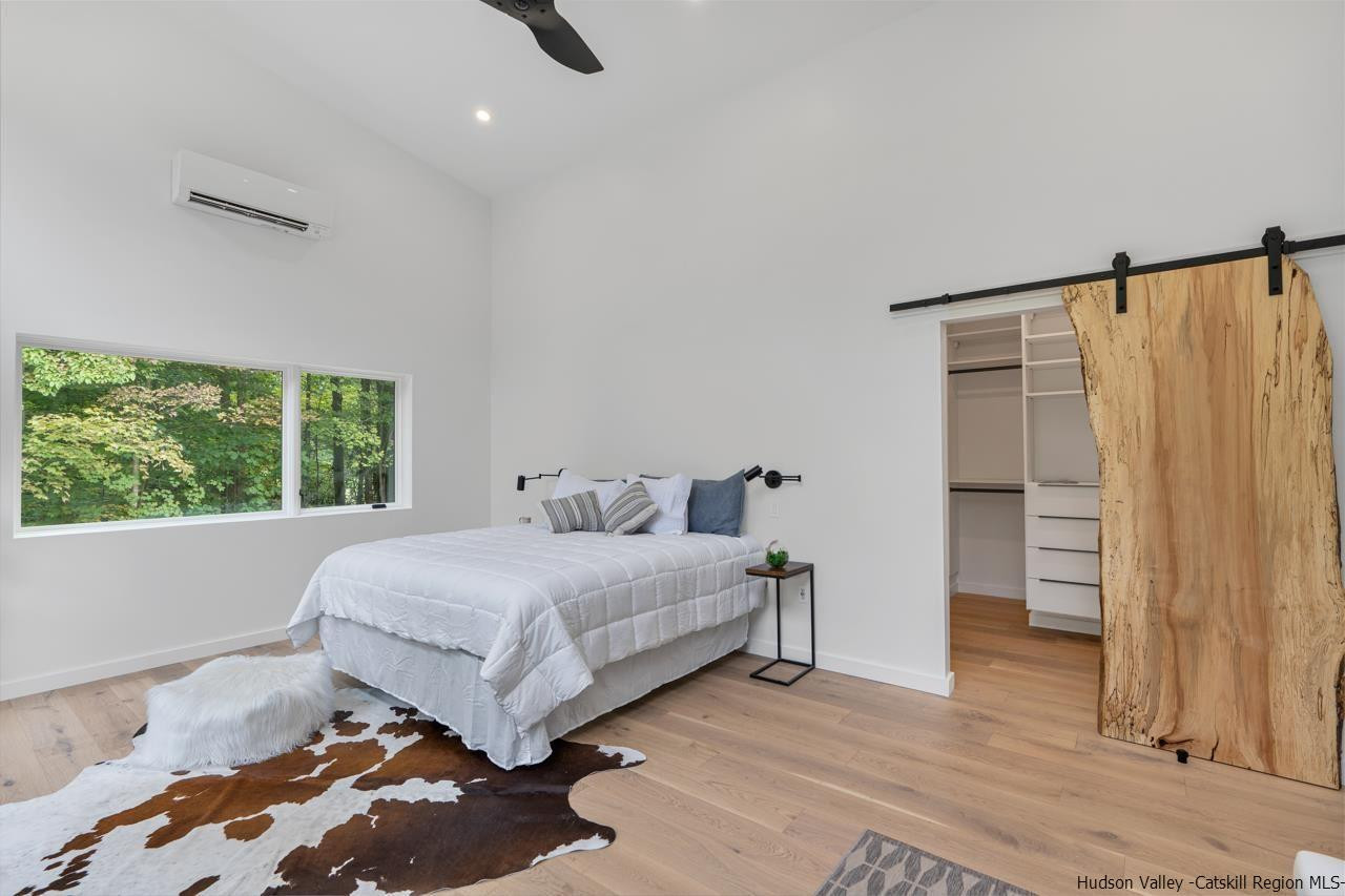 139 Krum Road Kerhonkson, NY 12446 - Photo 16 of 35 a bedroom with a large bed and a window