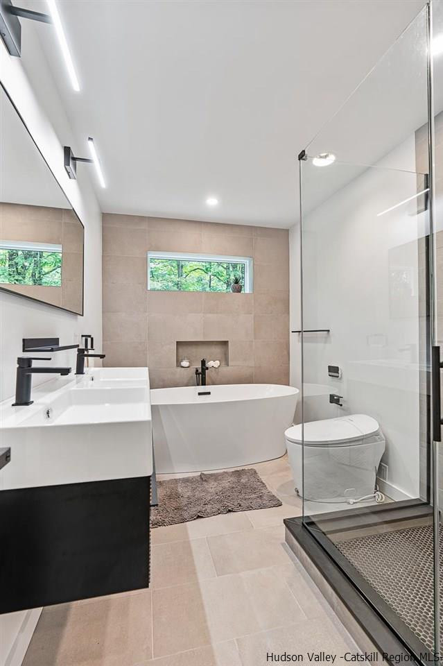 139 Krum Road Kerhonkson, NY 12446 - Photo 18 of 35 a large white kitchen with a sink a large window and stainless steel appliances