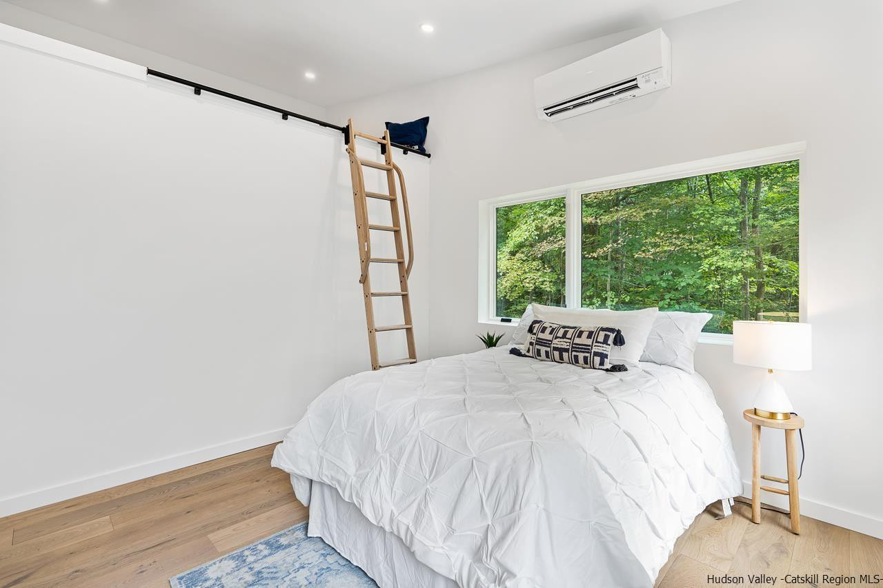 139 Krum Road Kerhonkson, NY 12446 - Photo 20 of 35 a bedroom with a bed and a window