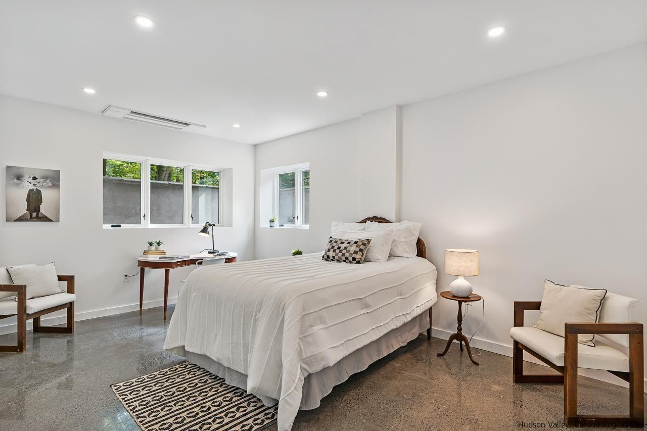 139 Krum Road Kerhonkson, NY 12446 - Photo 26 of 35 a bedroom with a bed a table and chair