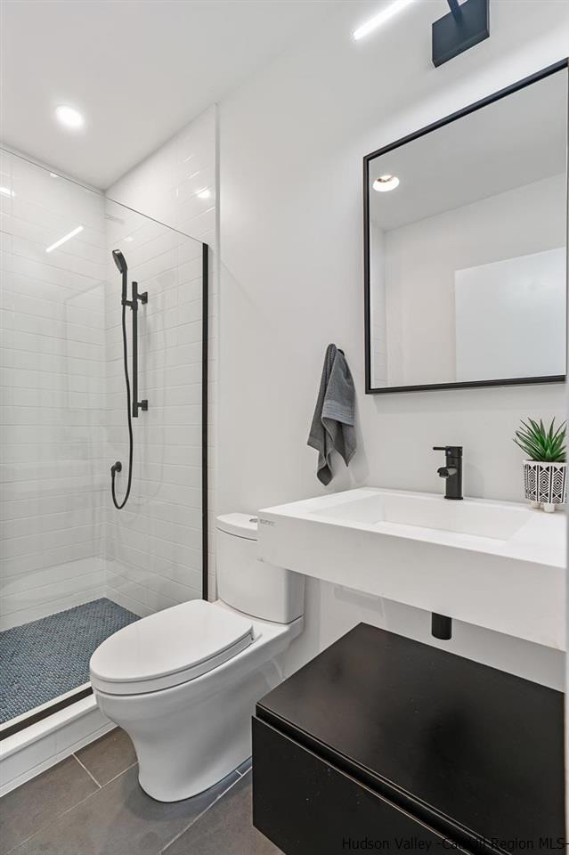 139 Krum Road Kerhonkson, NY 12446 - Photo 28 of 35 a bathroom with a sink a toilet and shower