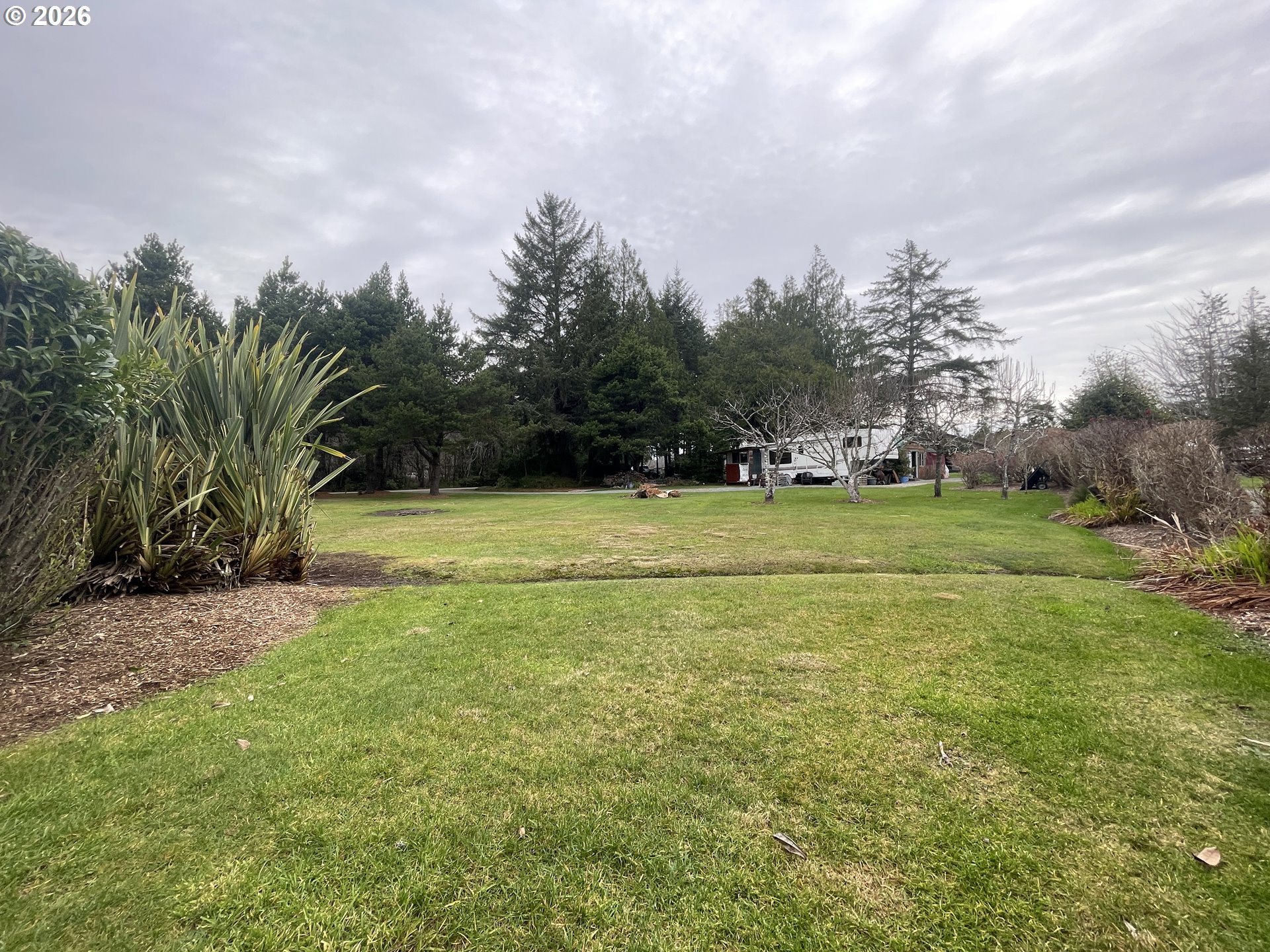 Cozy Pines Bandon, OR 97411 - Photo 2 of 13 a view of a water fountain and a big yard