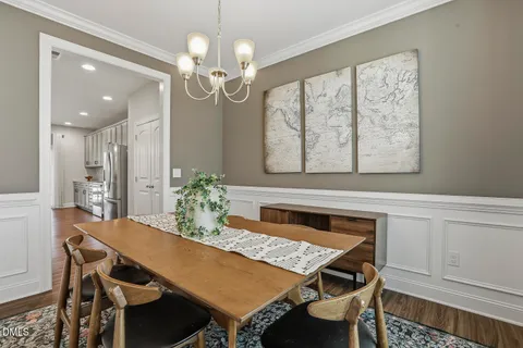 a kitchen with stainless steel appliances granite countertop a refrigerator a sink dishwasher a stove and oven with wooden floor