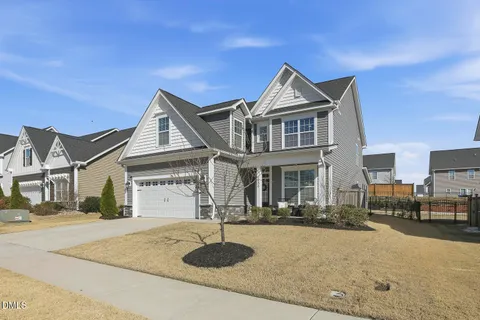 a front view of a house with a window and outdoor seating