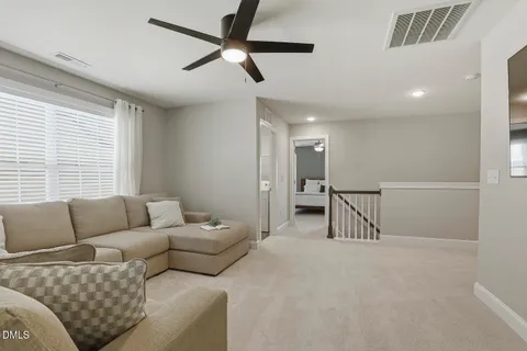 a bedroom with a large bed and a ceiling fan