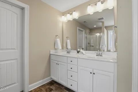 a bathroom with a sink vanity and a mirror