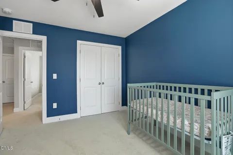 a view of a patio with couches and table and chairs with wooden fence