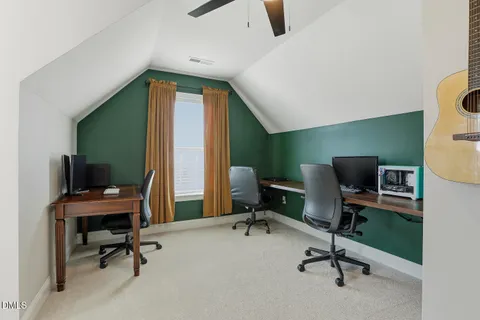 a view of a porch with furniture and a yard