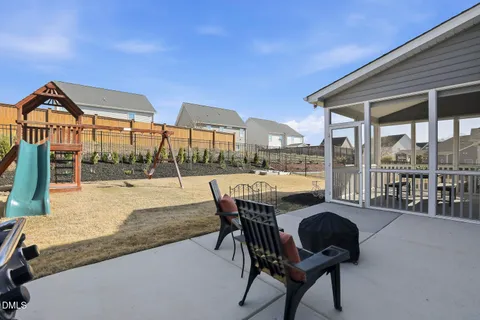 a view of a field with an trees in the background