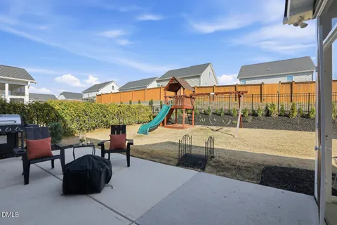 a view of a swimming pool with sitting area and furniture