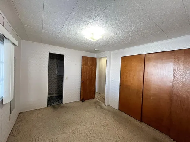an empty room with closet area