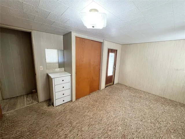 an empty room with closet and cabinet