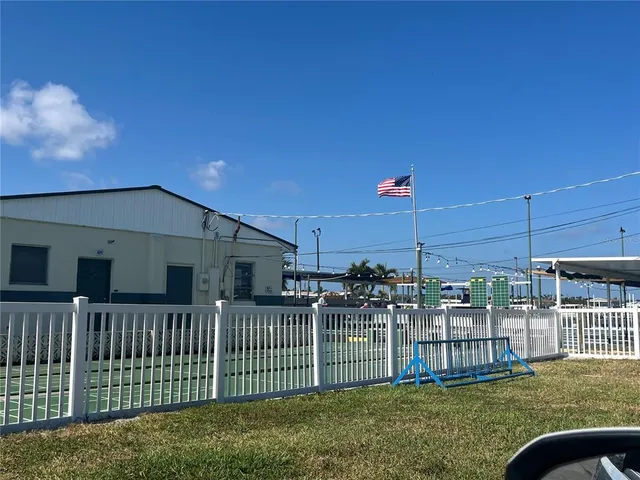 a view of a house with a small yard and furniture