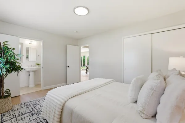 a bedroom with a bed and a potted plant