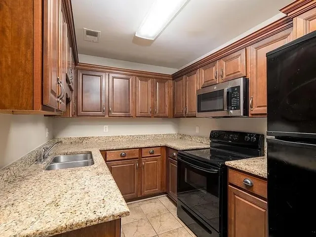 a kitchen with a sink stove and microwave