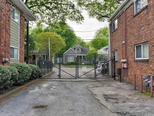 a view of a house with a large window and potted plants