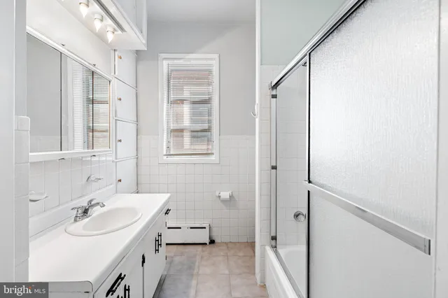 a bathroom with a sink a mirror and a shower