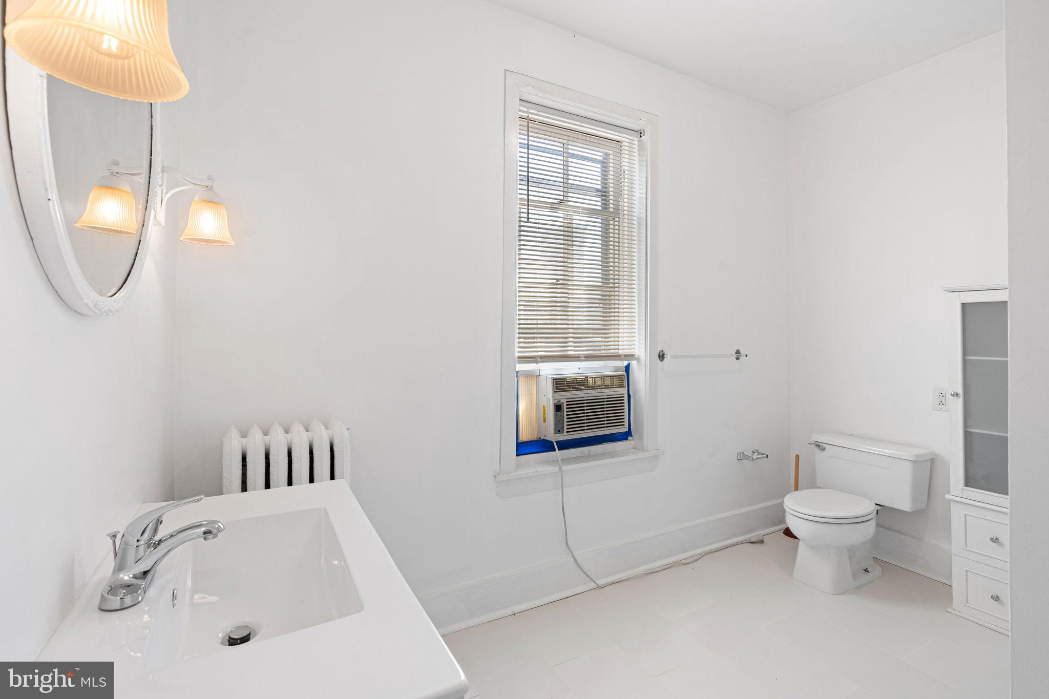 2324 Poplar Street, Unit 2F Philadelphia, PA 19130 - Photo 12 of 17 a bathroom with a sink and a toilet