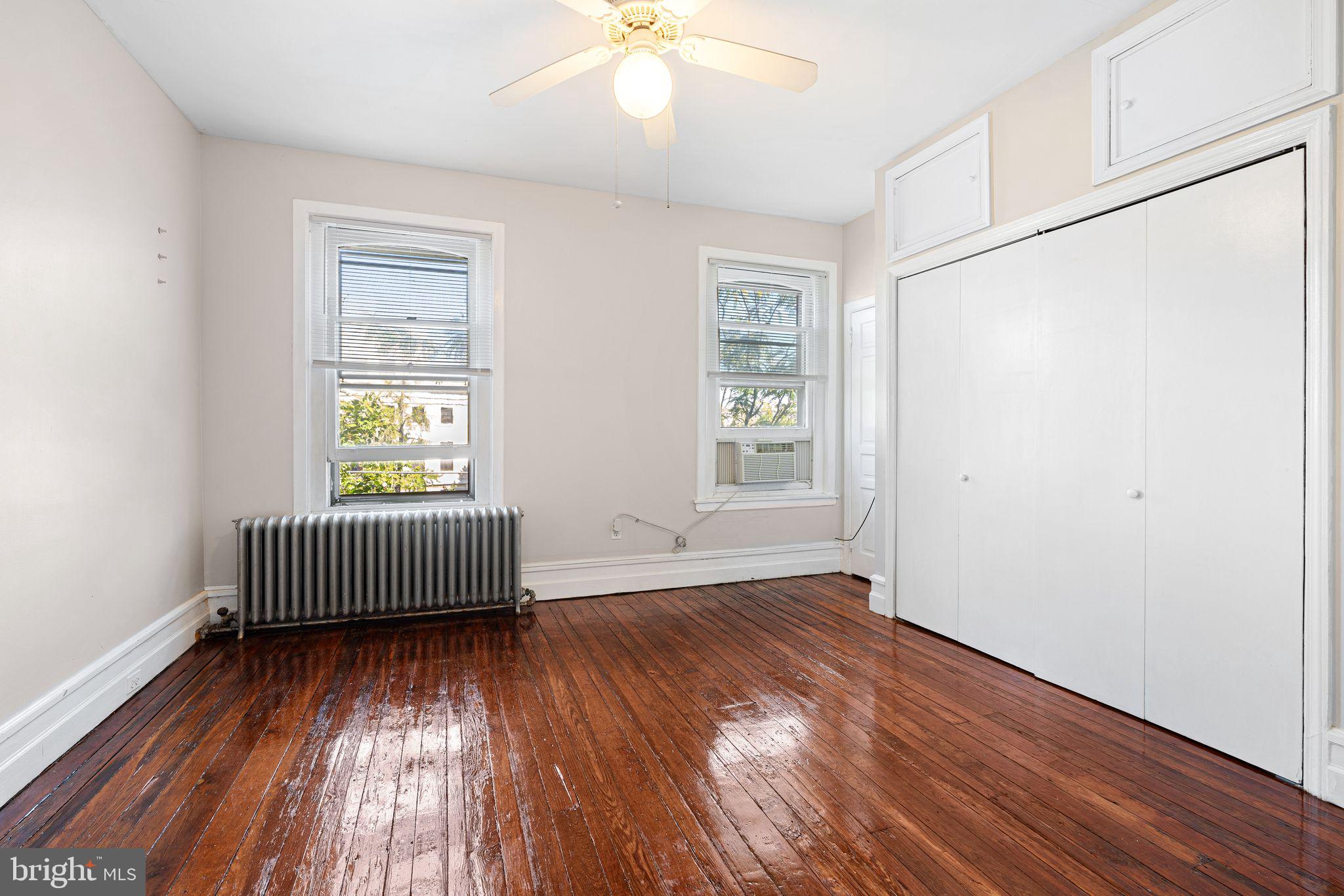 2324 Poplar Street, Unit 2F Philadelphia, PA 19130 - Photo 15 of 17 an empty room with wooden floor and windows