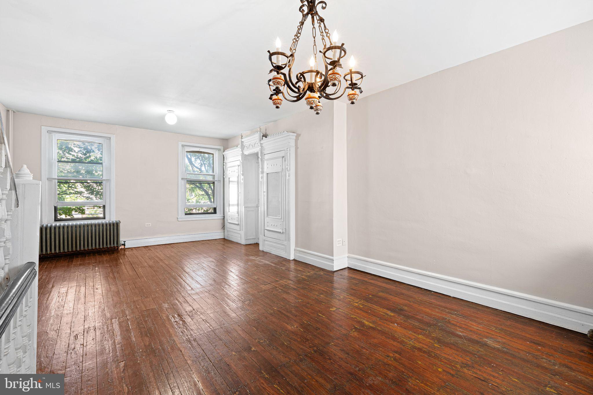 2324 Poplar Street, Unit 2F Philadelphia, PA 19130 - Photo 3 of 17 a view of an empty room with wooden floor and a window