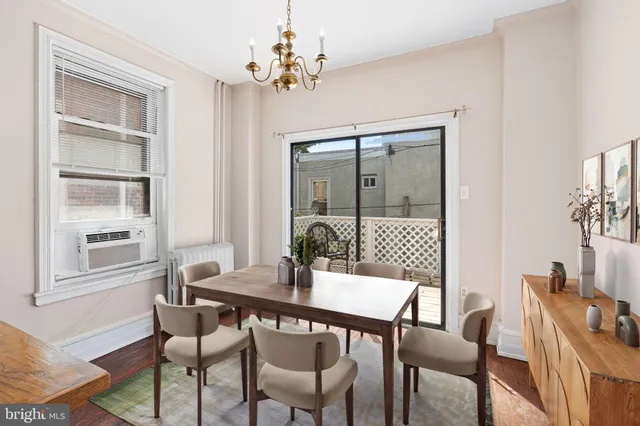 a dining room with furniture a chandelier and window