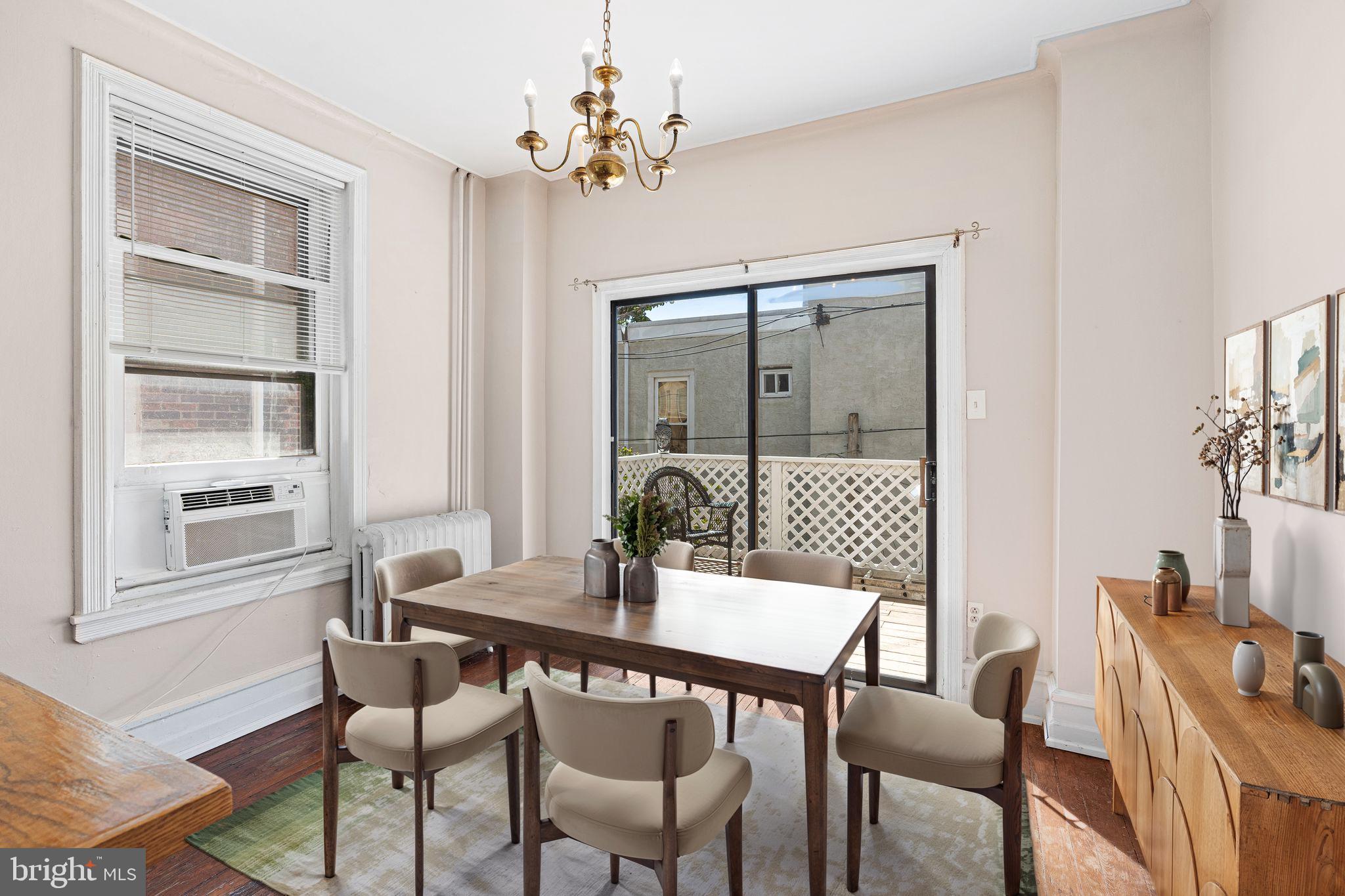 2324 Poplar Street, Unit 2F Philadelphia, PA 19130 - Photo 5 of 17 a dining room with furniture a chandelier and window