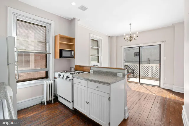 a kitchen with a stove a sink and a refrigerator
