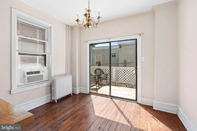 a view of a livingroom with wooden floor and cabinet