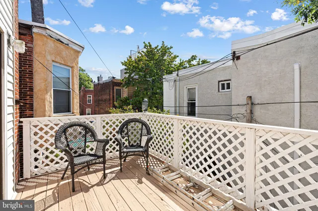 a view of a patio with a table and chairs