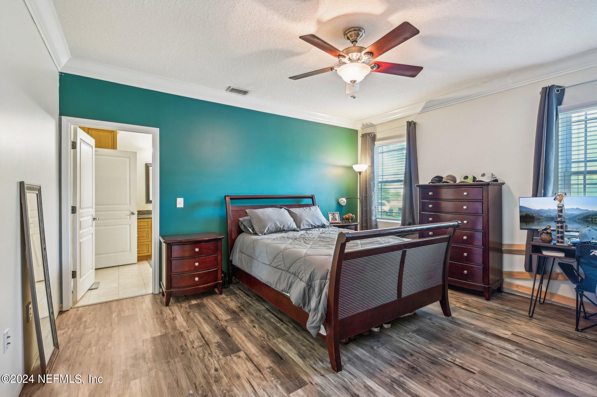4253 Dalry Drive Jacksonville, FL 32246 - Photo 13 of 40 a bedroom with a bed and a table in it