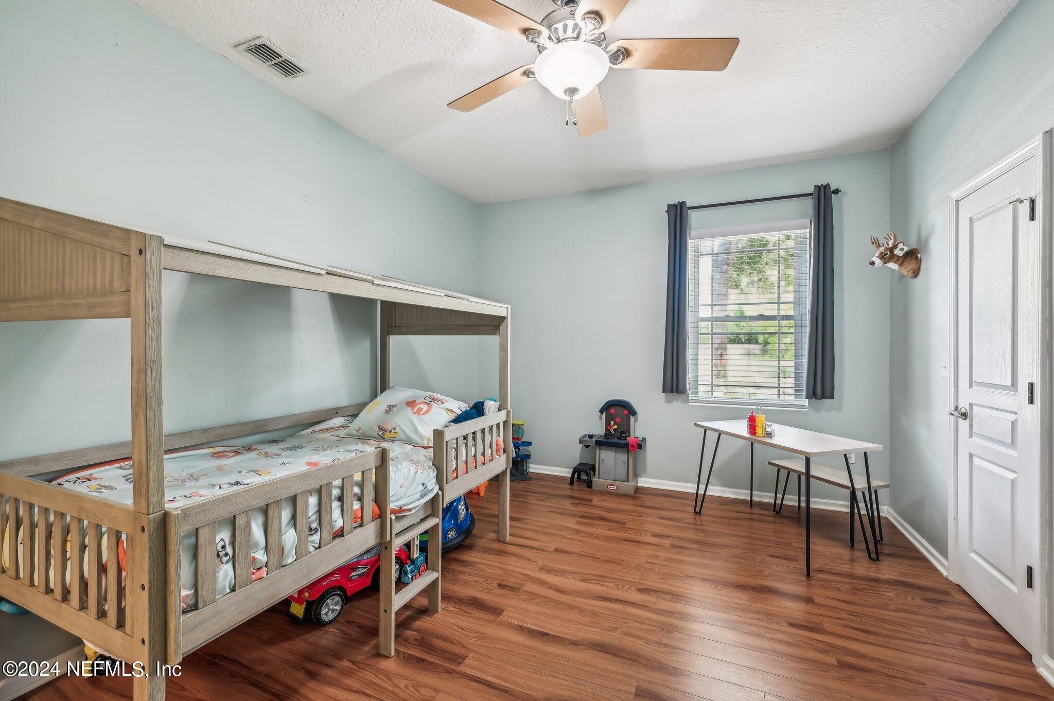 4253 Dalry Drive Jacksonville, FL 32246 - Photo 19 of 40 a bedroom with furniture and a window