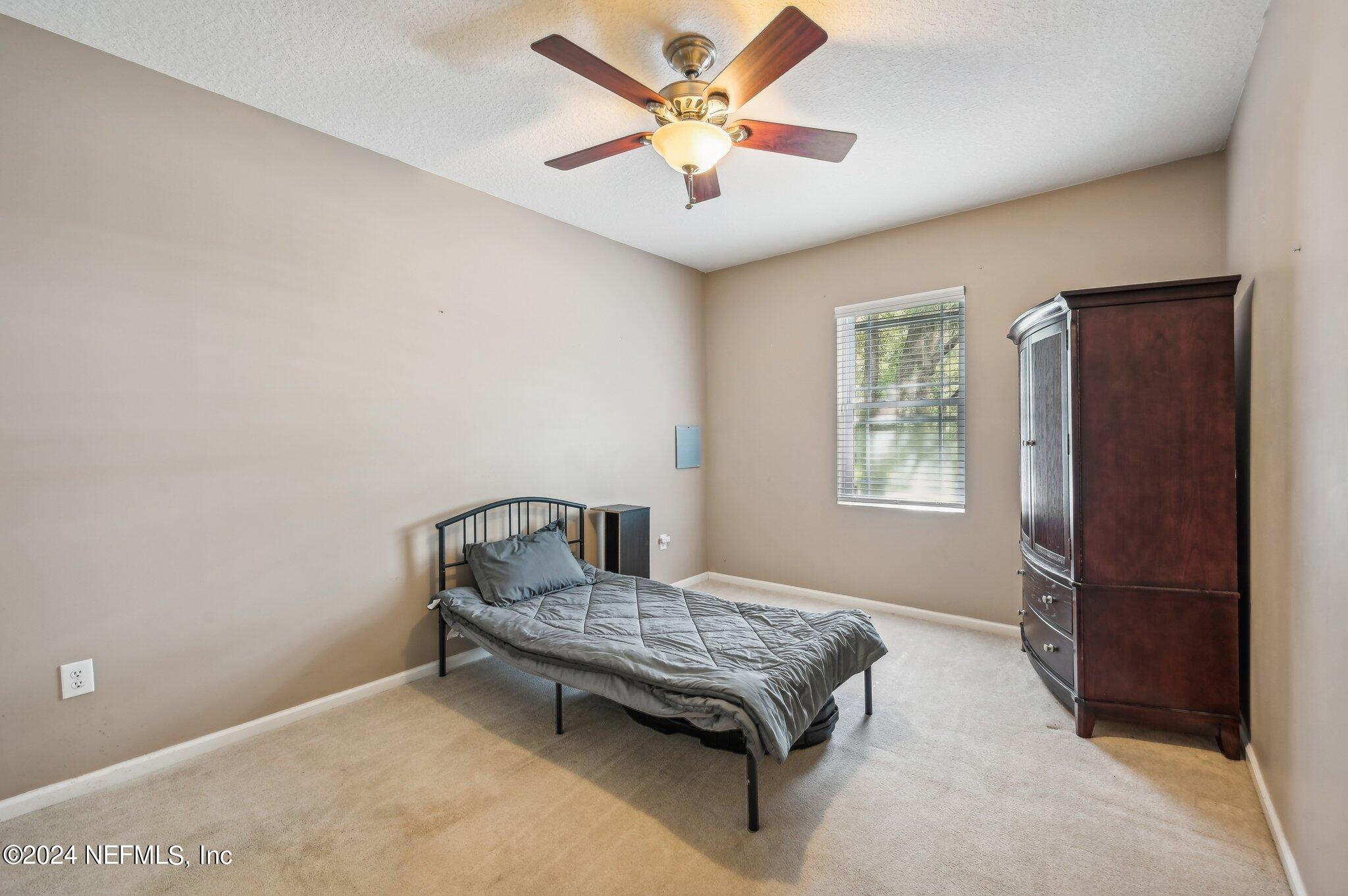 4253 Dalry Drive Jacksonville, FL 32246 - Photo 21 of 40 a bedroom with a bed and a window