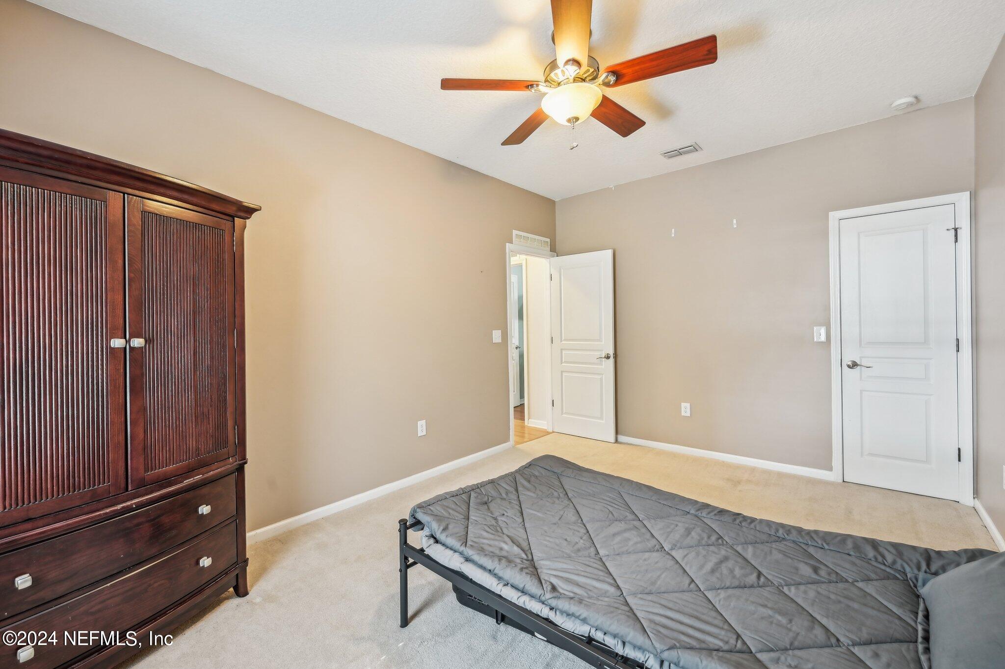4253 Dalry Drive Jacksonville, FL 32246 - Photo 22 of 40 an empty room with closet and fan