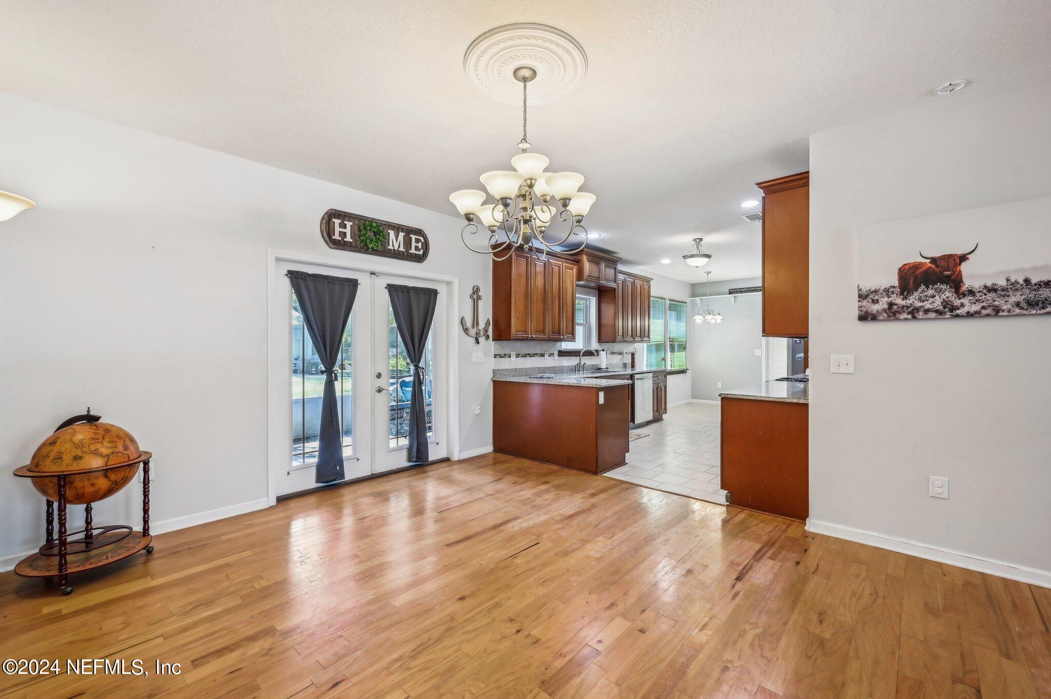 4253 Dalry Drive Jacksonville, FL 32246 - Photo 24 of 40 a view of a kitchen with kitchen island stainless steel appliances granite countertop a stove and a wooden floors