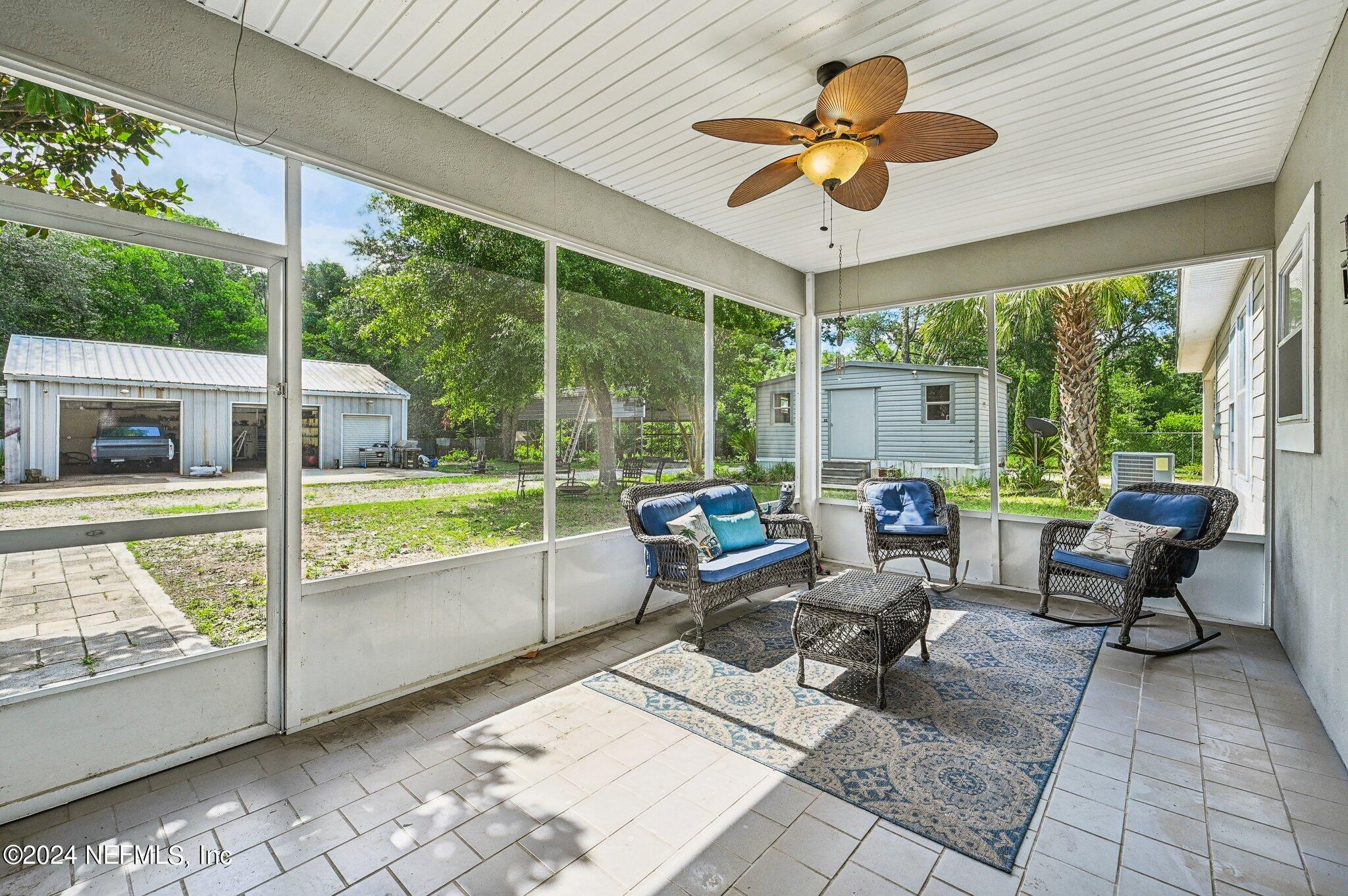 4253 Dalry Drive Jacksonville, FL 32246 - Photo 27 of 40 a living room with patio area and garden view
