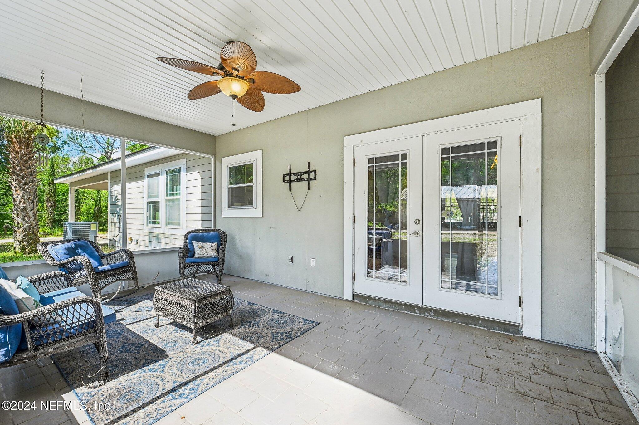 4253 Dalry Drive Jacksonville, FL 32246 - Photo 28 of 40 a living room with furniture chandelier and a large window