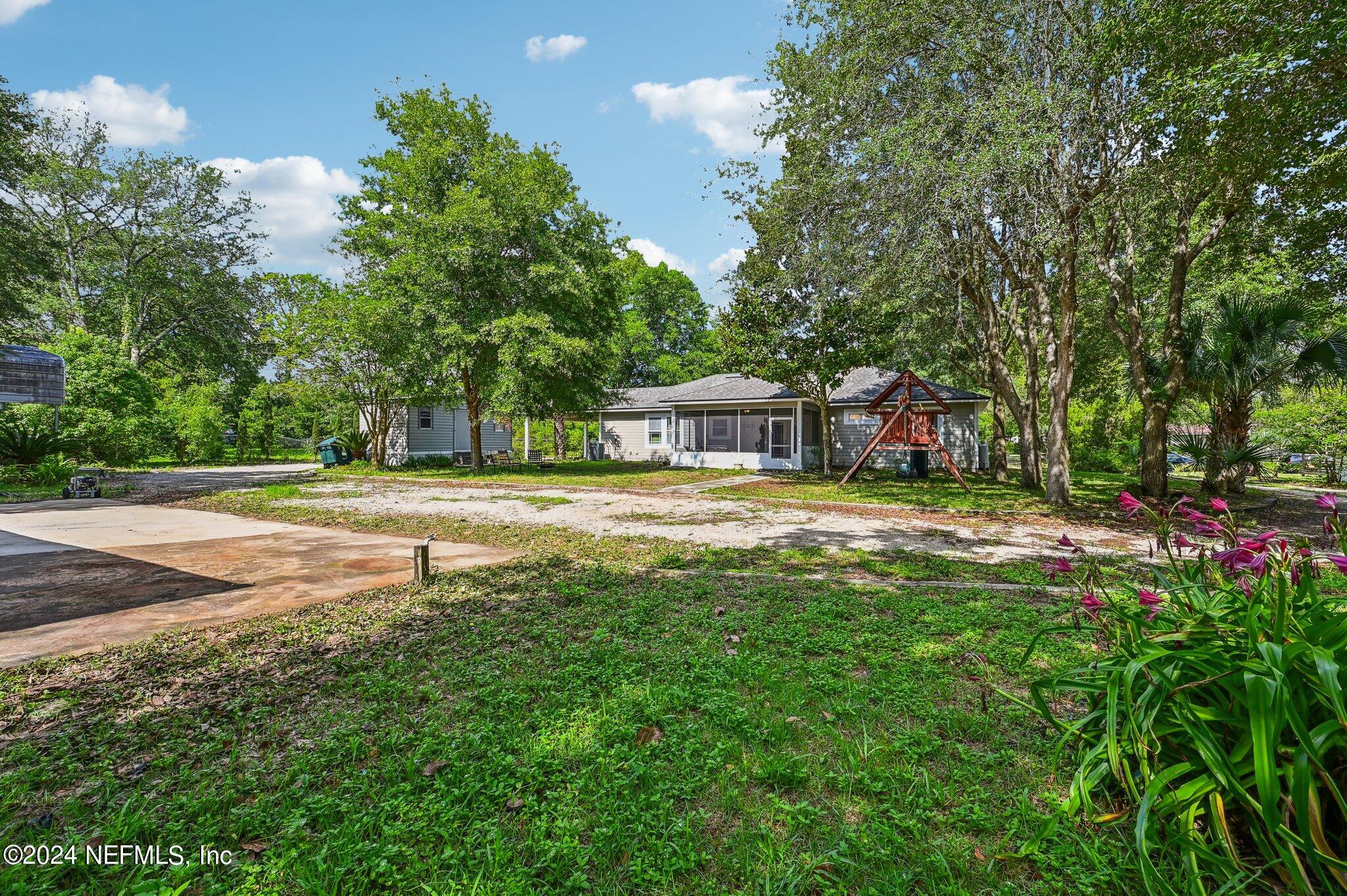 4253 Dalry Drive Jacksonville, FL 32246 - Photo 30 of 40 a swimming pool is sitting in the middle of a big yard
