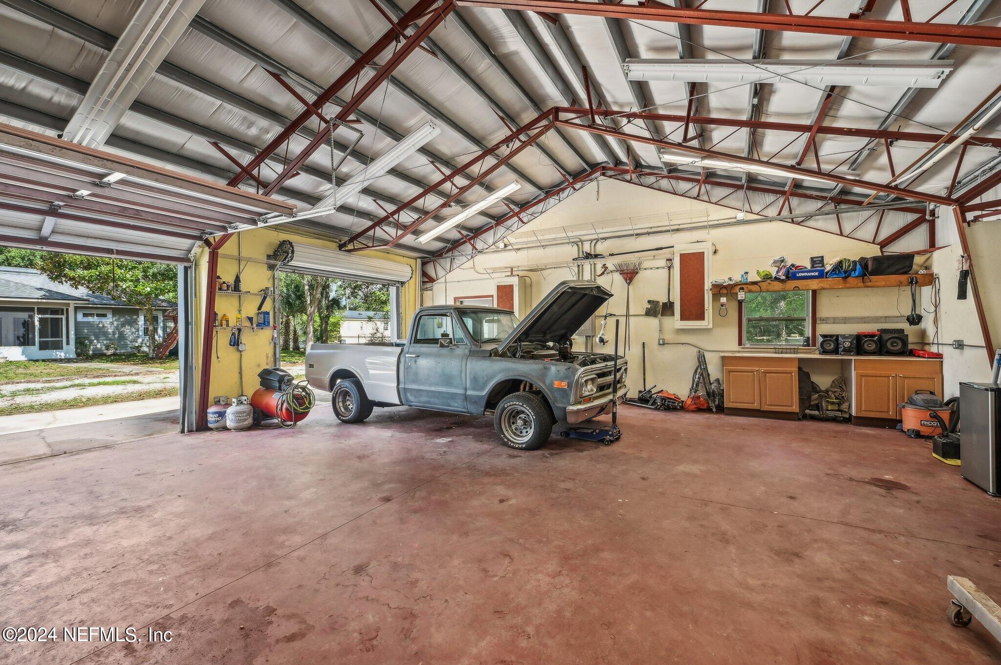 4253 Dalry Drive Jacksonville, FL 32246 - Photo 39 of 40 a view of a garage with parked cars