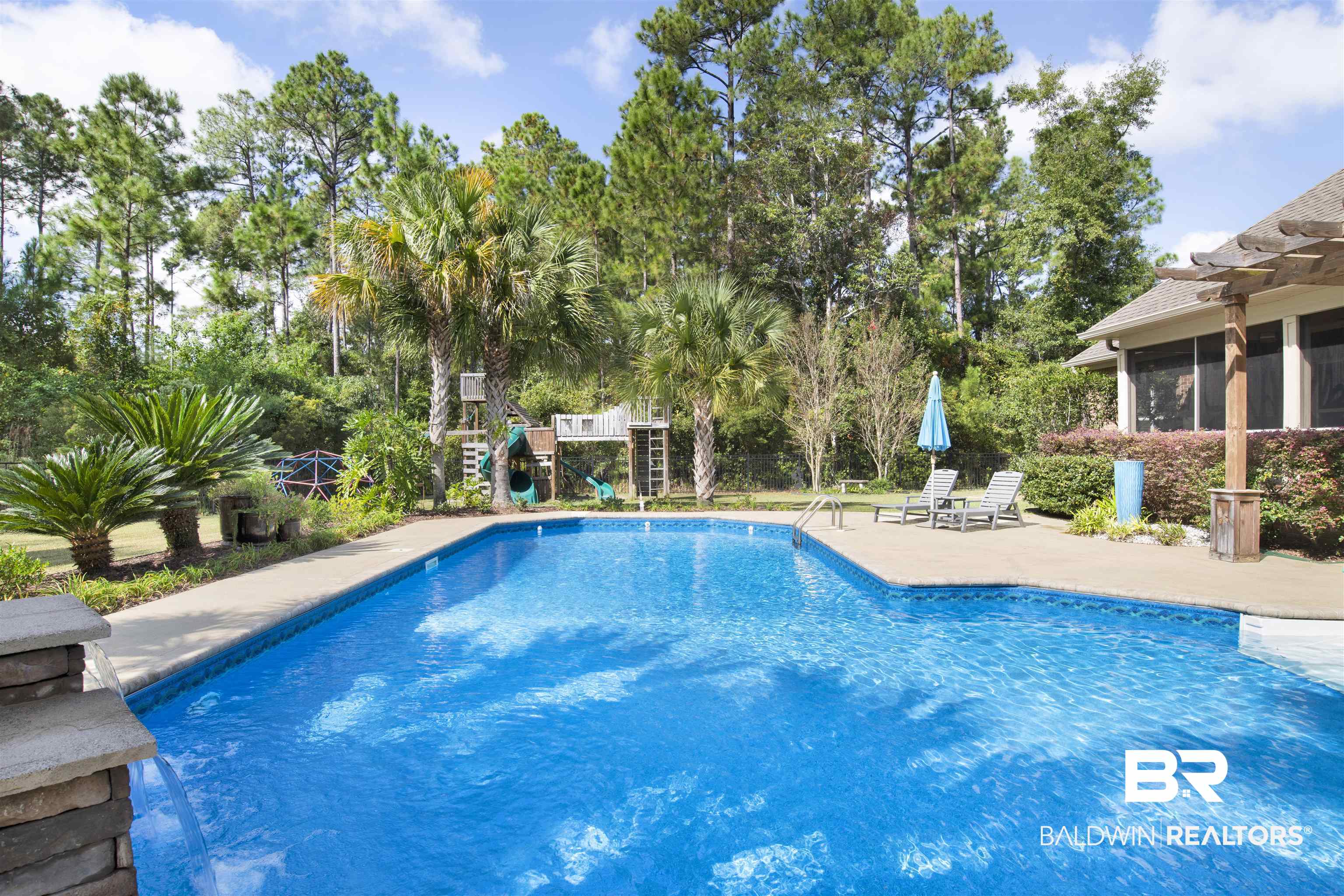18360 Treasure Oaks Road Gulf Shores, AL 36542 - Photo 49 of 57 View of swimming pool featuring a patio area and a playground