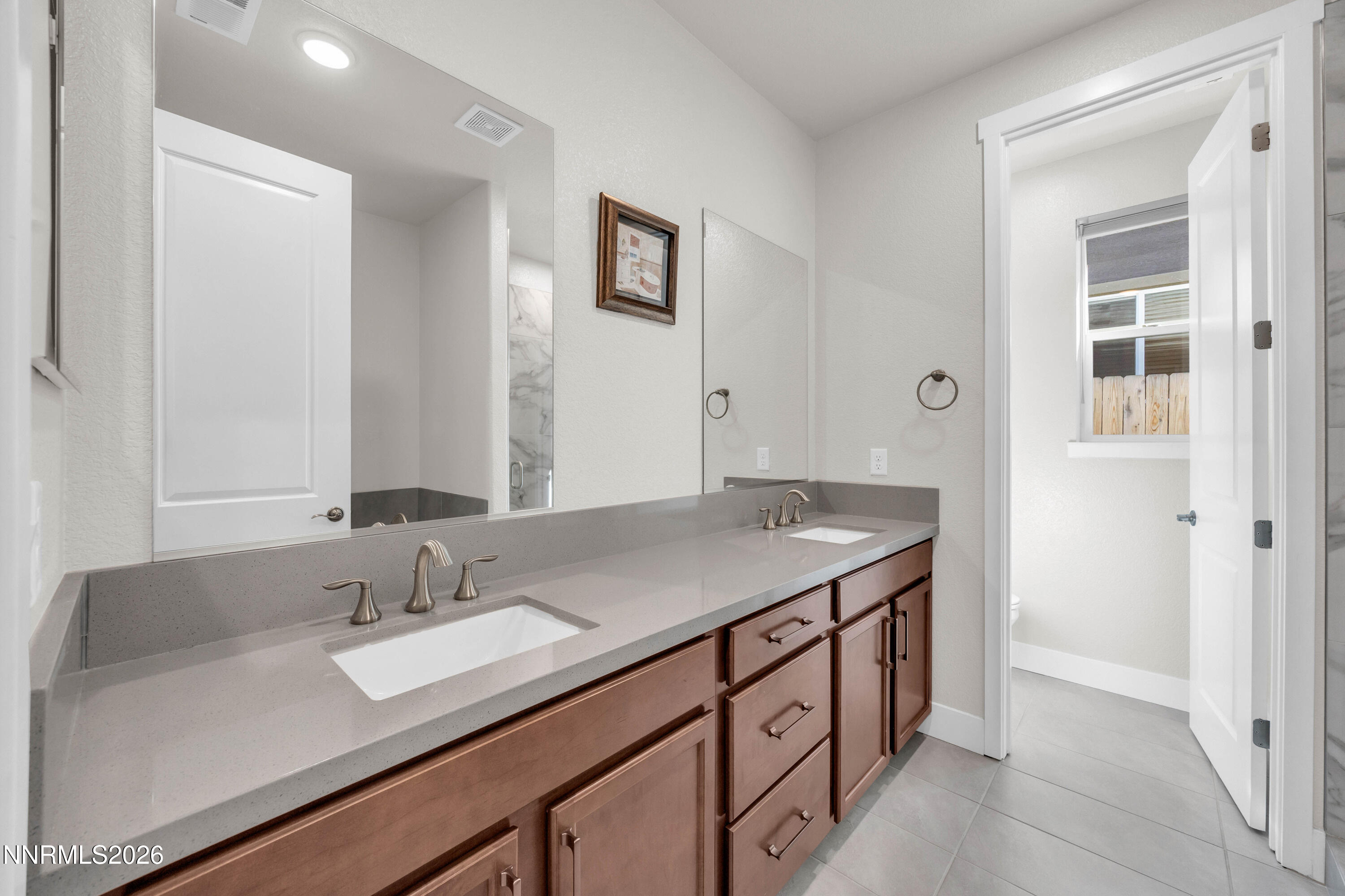 7774 Enclave Key Road Reno, NV 89506 - Photo 13 of 26 a bathroom with a sink and a mirror