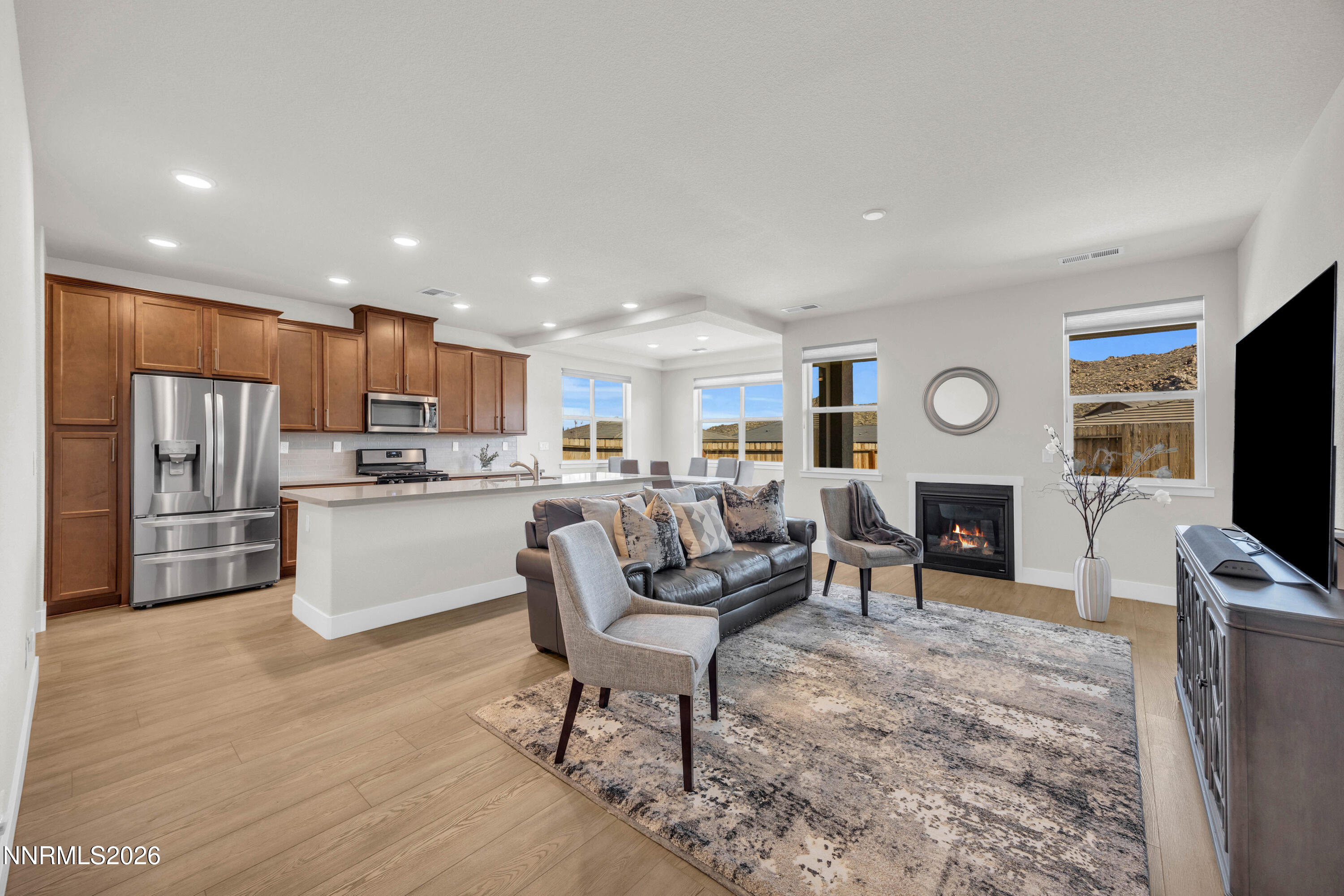 7774 Enclave Key Road Reno, NV 89506 - Photo 4 of 26 a living room with stainless steel appliances furniture a flat screen tv and kitchen view