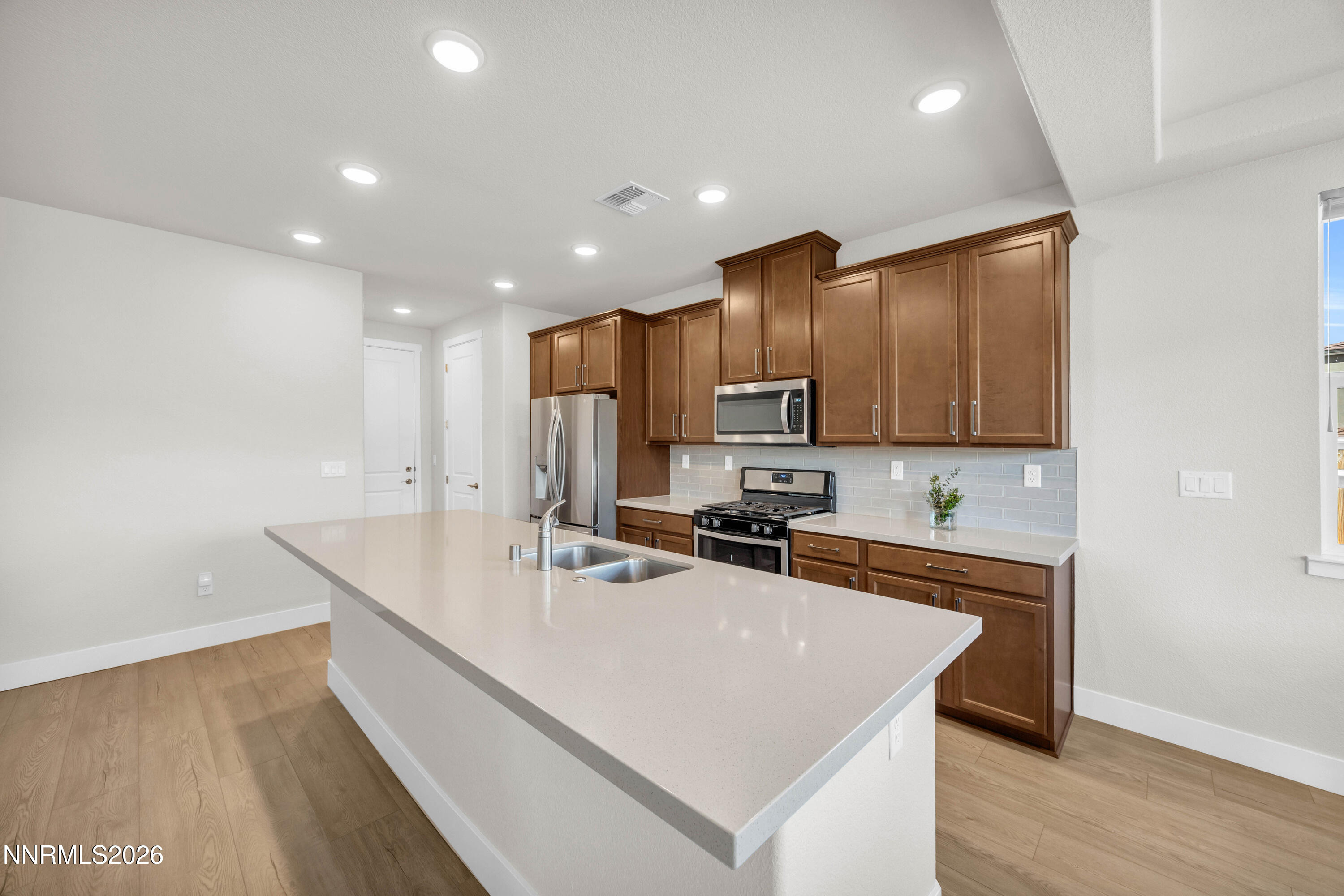 7774 Enclave Key Road Reno, NV 89506 - Photo 6 of 26 a kitchen with stainless steel appliances a sink stove and refrigerator