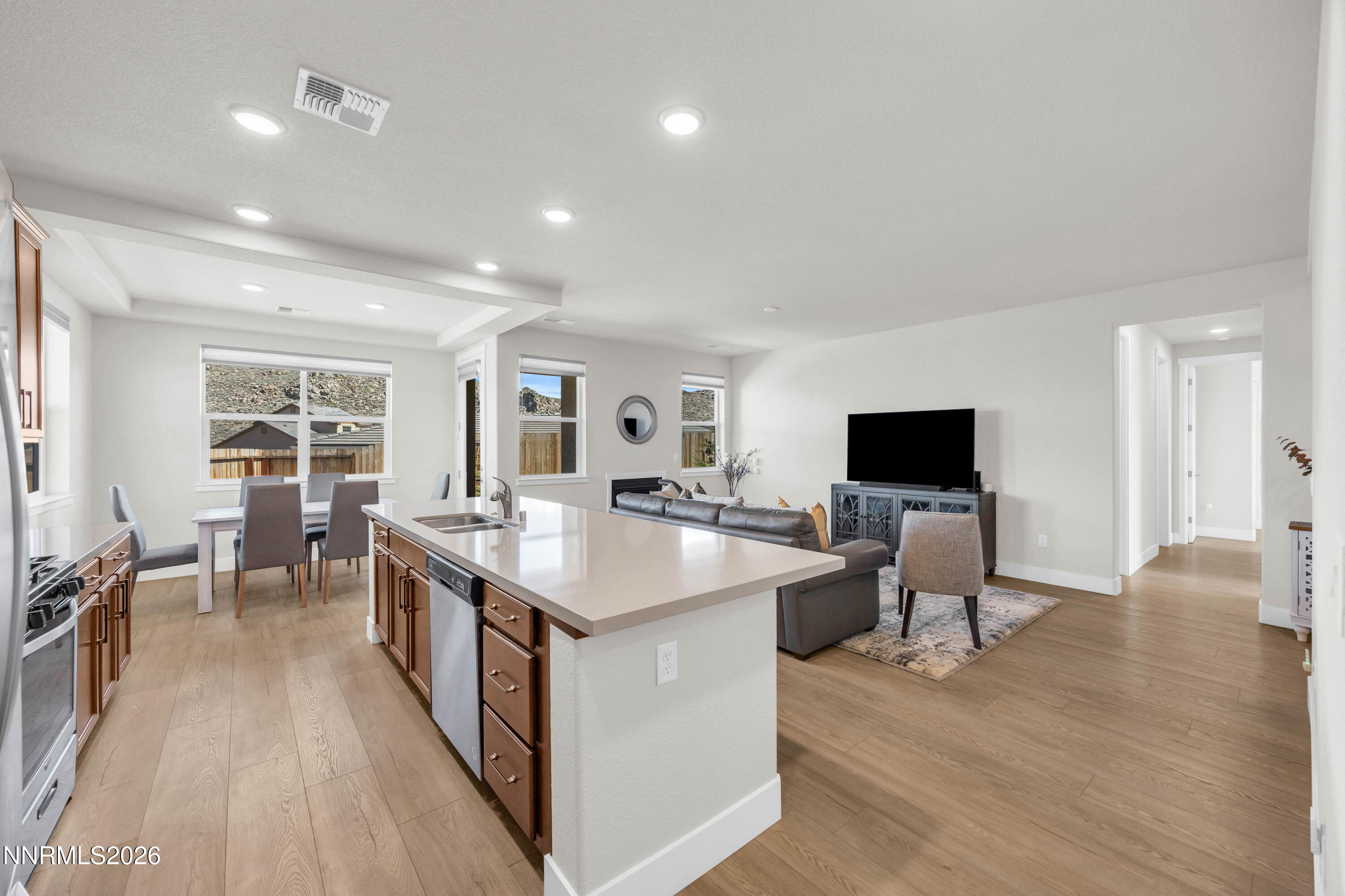 7774 Enclave Key Road Reno, NV 89506 - Photo 8 of 26 a living room with furniture a flat screen tv and a refrigerator