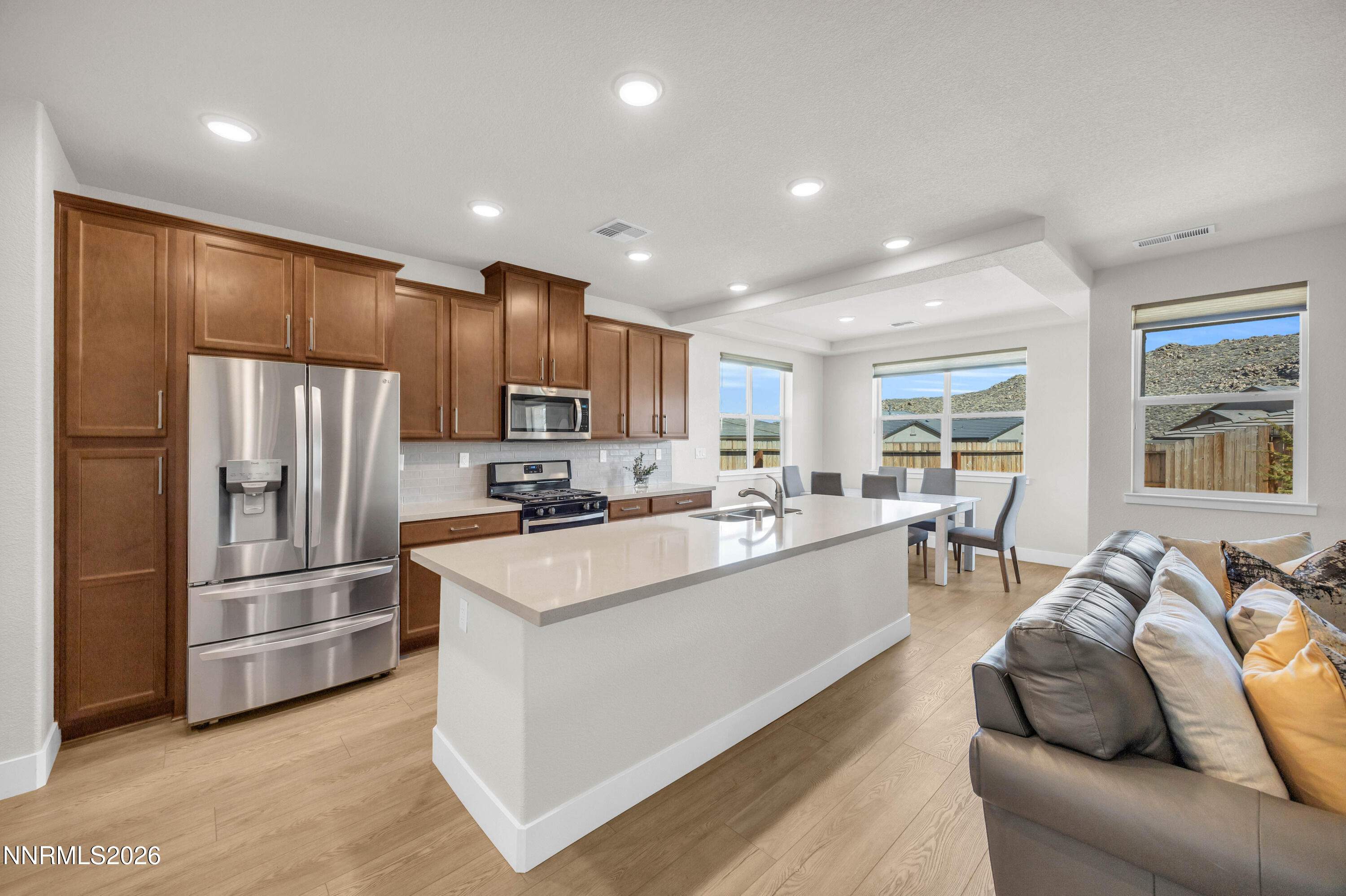 7774 Enclave Key Road Reno, NV 89506 - Photo 9 of 26 a living room with stainless steel appliances furniture cabinets and a window