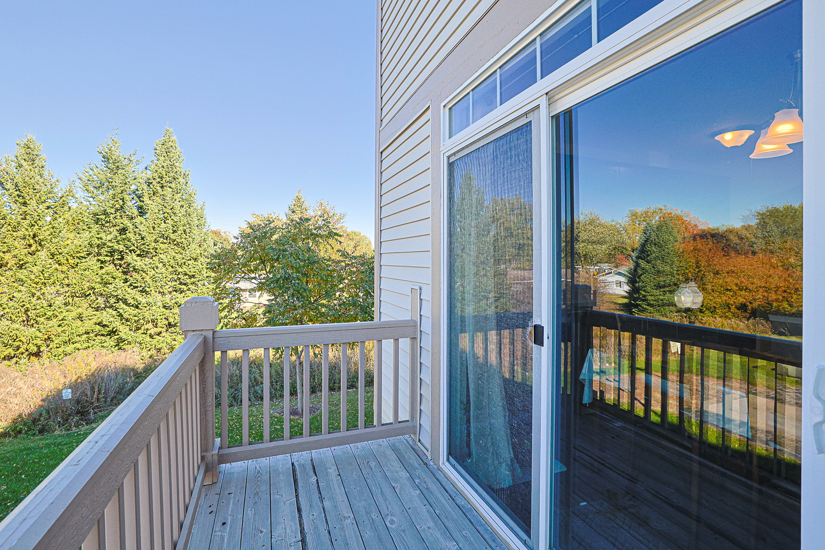 299 Bennett Drive Carol Stream, IL 60188 - Photo 14 of 27 a view of a balcony with wooden floor and fence