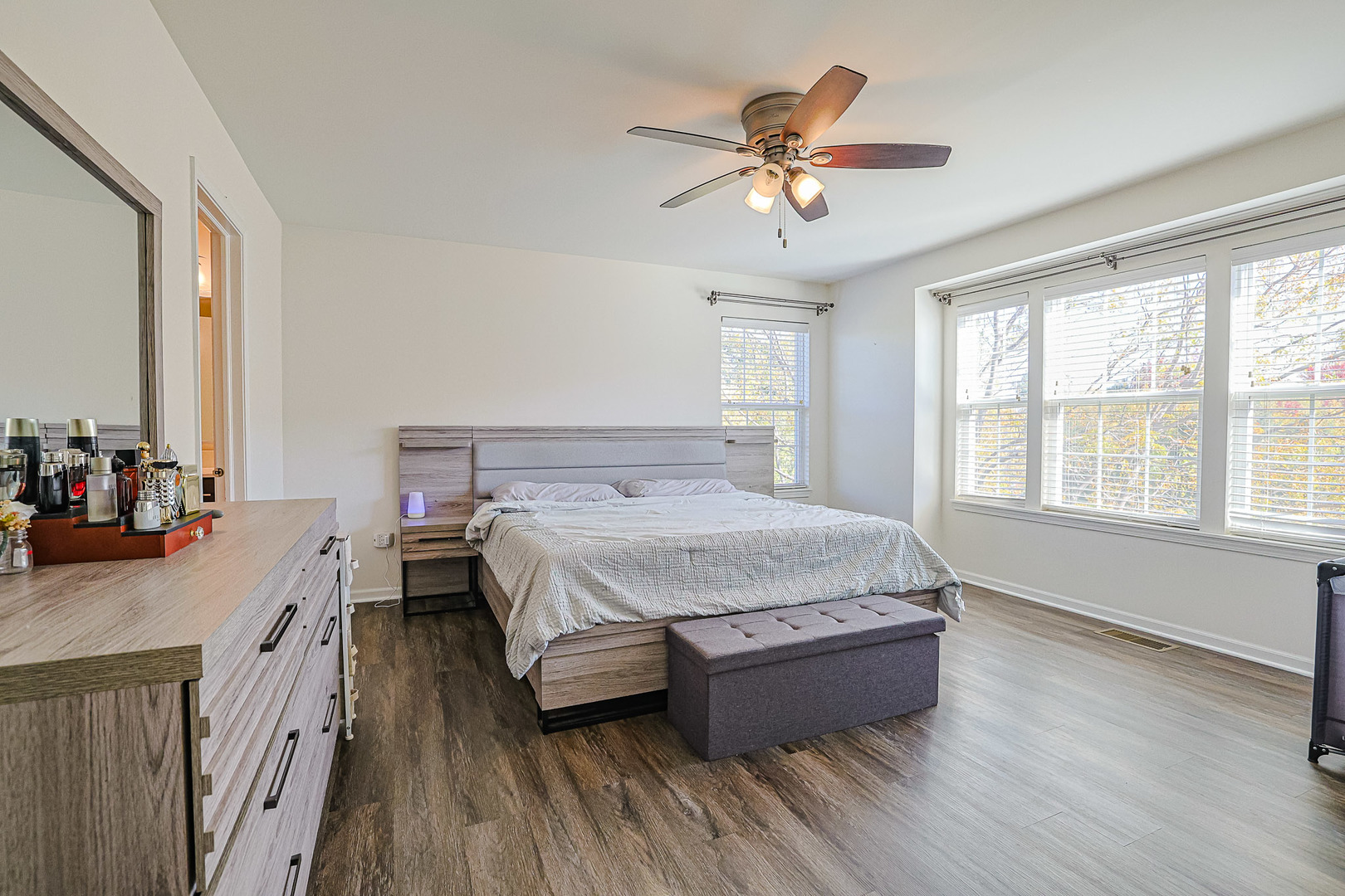 299 Bennett Drive Carol Stream, IL 60188 - Photo 23 of 27 a spacious bedroom with a bed a dresser and wooden floor