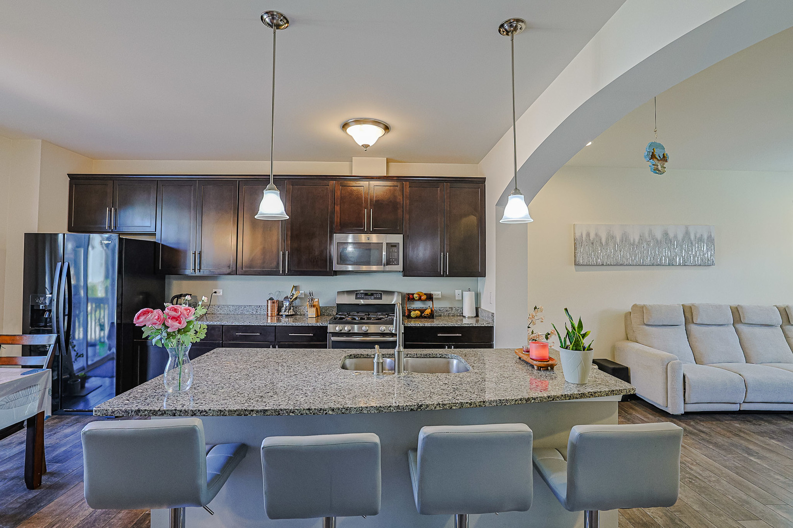299 Bennett Drive Carol Stream, IL 60188 - Photo 7 of 27 a kitchen with granite countertop kitchen island stainless steel appliances a sink and a refrigerator