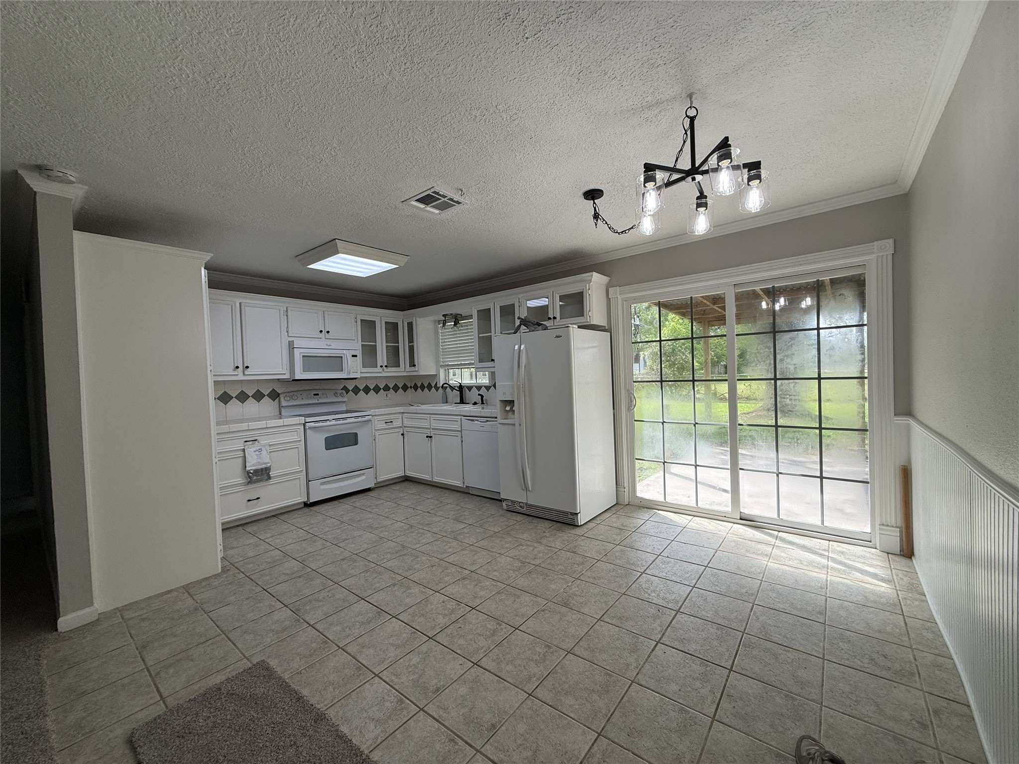 1902 Trinity League City, TX 77573 - Photo 2 of 11 a large white kitchen with a large window appliances and cabinets